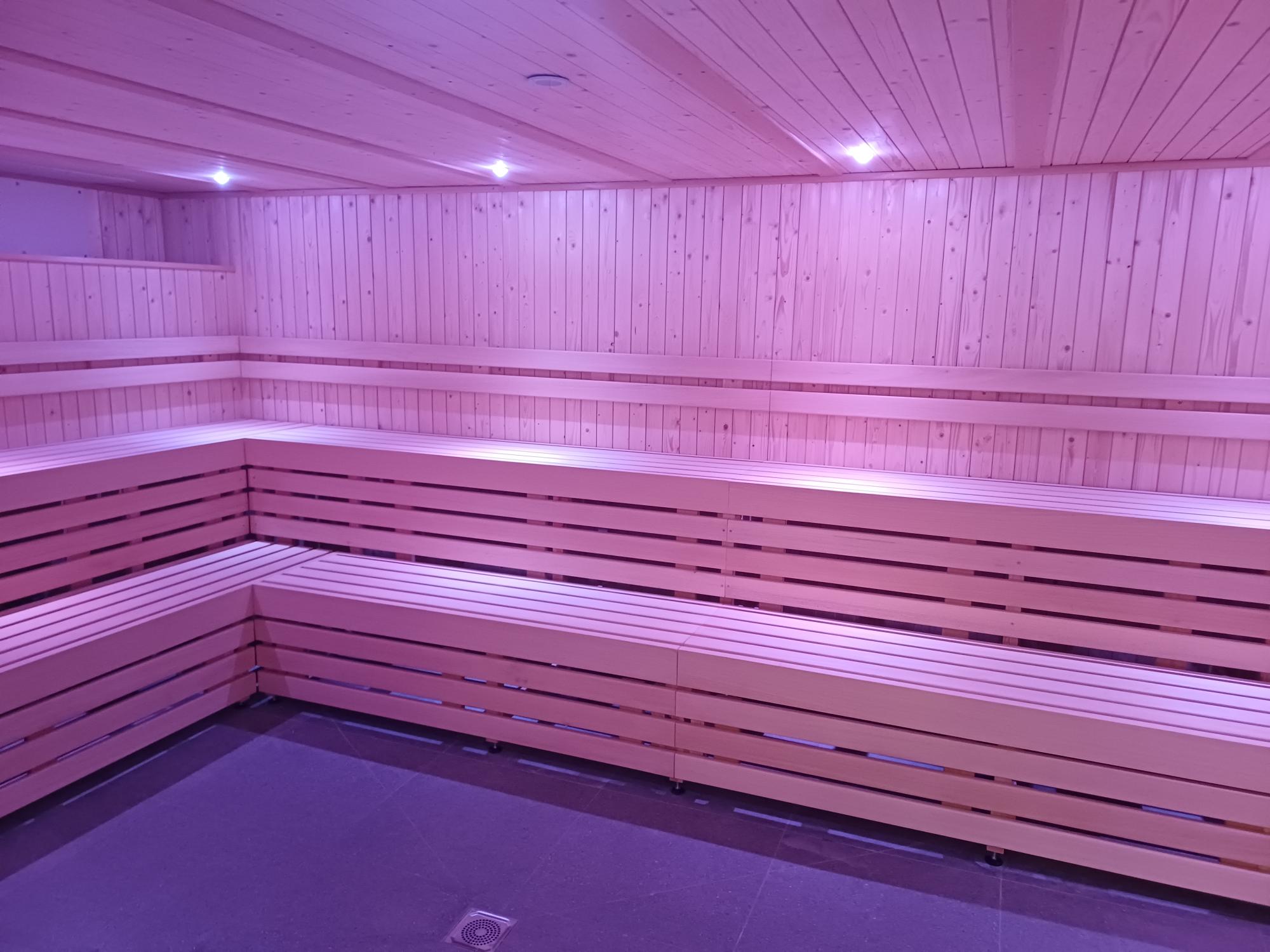 Brand new sauna seating with pink lighting